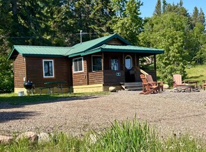 Eve's Place Cabin 2 with darling front porch and firepit. Charcoal grill and picnic table front left