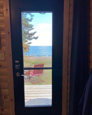 Glorious view from the full glass front door. Storm door with hidden screen. Enjoy the lake breeze.