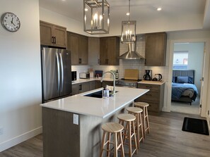 Beautiful kitchen with Quartz counters, stainless appliances, bar seating