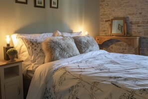 Pond Cottage, West Witton: Master bedroom with feature stone wall