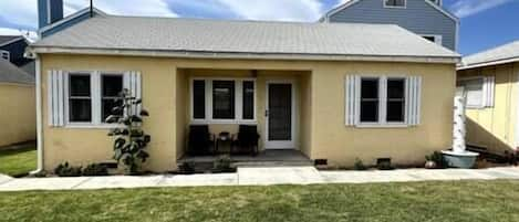 View of front of house. House is up drive way and off the street.