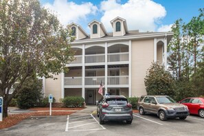View of front of condo and parking