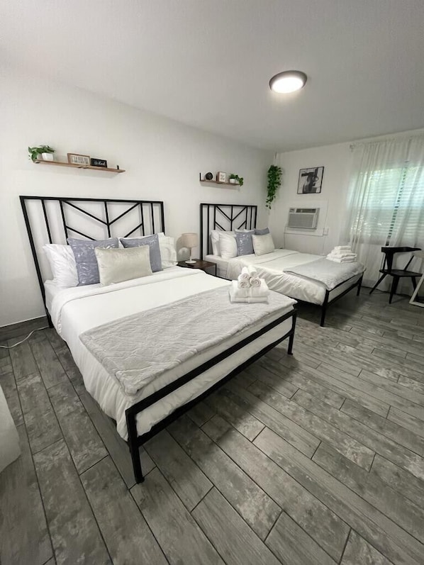 Lovely updated hotel style room with 2 Queen Beds, dining table, Mini fridge, smart TV, Kitchenette and private bathroom.