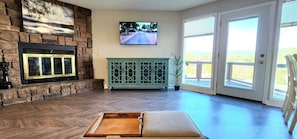 Living room includes electric simulated fireplace - switch on wall. (No smoke or wood deal with)