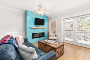 Living area with TV and access to balcony