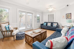 Living area with TV and access to balcony