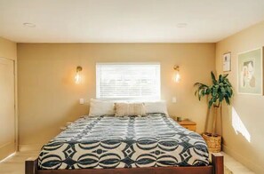 The main bedroom, complete with a California king bed and zen vibes. 