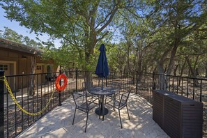Outdoor Patio: Savor tranquil moments under the umbrella amid lush trees and scenic views!