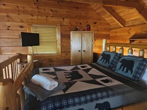 Enjoy a pet-friendly cabin in Sevierville with a rustic loft bedroom, charming wood interiors, a plush bed with bear-themed decor, and a private TV. This romantic Sevierville cabin rental offers a mountain view, perfect for unwinding after exploring nearby Pigeon Forge.