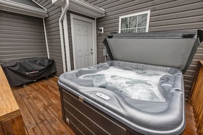 Newly installed hot tub with privacy screening on the back deck