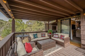 The outdoor deck includes a dining table and grill for outdoor entertaining.