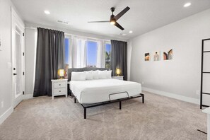 This beautifully appointed master bedroom offers a plush king-size bed for a peaceful night's sleep. Relax with a movie on the flat-screen TV, and enjoy the luxury of your own attached bathroom, creating a serene personable escape.