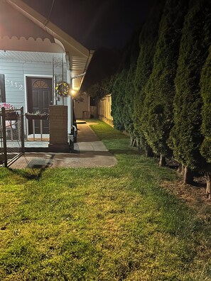 Outdoor area, fully fenced, at night.