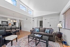 Relax in a welcoming, well-lit living room.