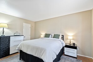Spacious bedroom with elegant decor and style.