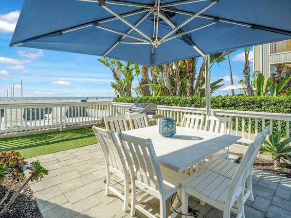 Spacious front deck with ample seating and outdoor dining space.