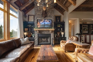 2nd Floor: Cozy living room featuring designer furnishings, a warm fireplace, and a large Smart TV for entertainment.