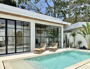 Outdoor area with a swimming pool and  lounge chairs