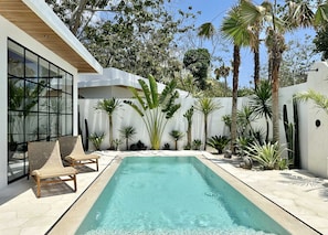 Outdoor area with a private swimming pool and lounge chairs