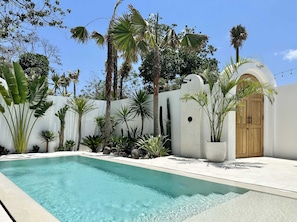 Sunny outdoor area with an outdoor shower