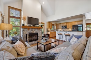 The open floor plan is great for entertaining—the space is extra cozy with a fire roaring in the fireplace!