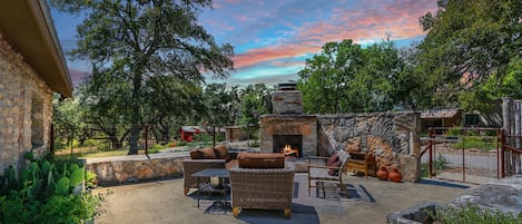Enjoy a cozy evening by the fireplace under the open Texas sky
