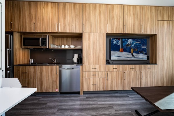 Enjoy the cabinetry that houses everything you need, from the kitchen to the living room / sleeping area.
