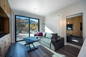 Enjoy the stunning mountain view from the living room as well as easy access to the outdoor patio / community area.