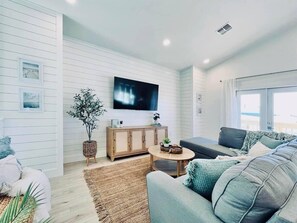 Living area with balcony access and smart tv