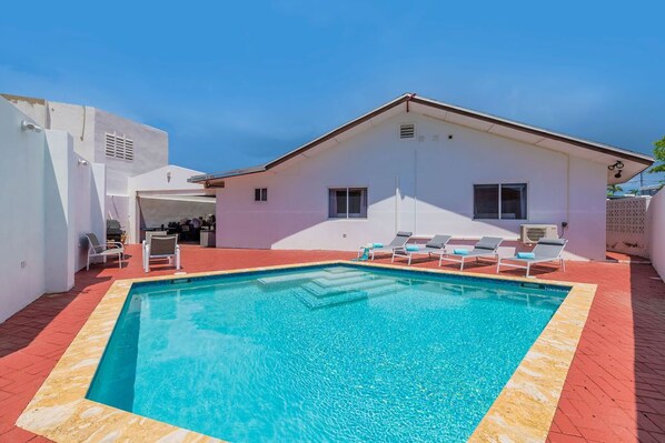 A spacious and relaxing pool area with sun loungers