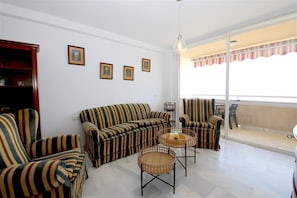 Bright and spacious living room with comfortable seating and terrace access