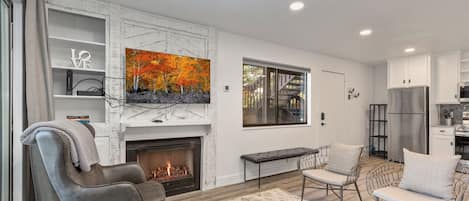 Warm ambiance with cozy fireplace, ample seating, and natural light.