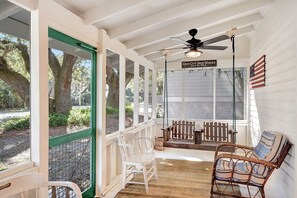 Screened Front Porch with Swing – The Stumble Home - Start your day on the breezy screened porch—or stroll to Crab Daddy’s, Crab Trap, Fiddler’s, and Barrier Brewery, all just a few steps from your front door.