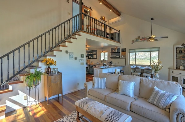 View of living room, dining area and stairway to master bedroom suite