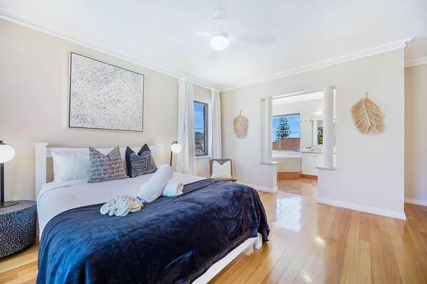 Unwind in this master bedroom retreat, featuring a queen-sized bed and a peaceful ambiance.