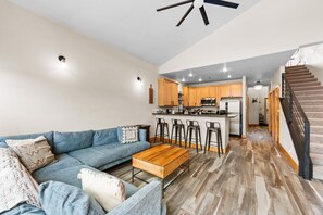 LLiving room with mountain views, private balcony, gas fireplace, and vaulted ceilings.