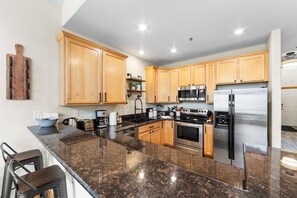 Kitchen with granite countertops and stainless steel appliances.