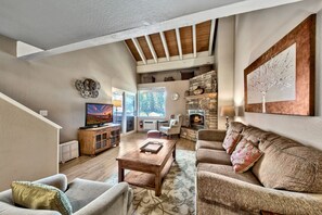 The living room with 2 arm chairs, comfortable couch and 42-inch TV