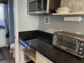 Gas stove, microwave and large countertop convection oven.