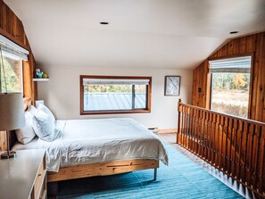 The master bedroom has a view in every direction, including mountains and fields