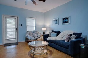 Living room with a cozy seating area and a Smart 4K TV for your entertainment.