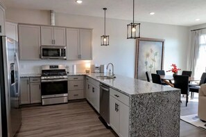 Open concept kitchen with gas stove and spacious breakfast bar