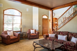 Large living room windows offer frame all the beauty the outdoors offer in this mountain escape.