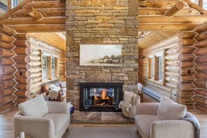 Enjoy a book or drinks with friends in this formal sitting area overlooking the custom stone fireplace