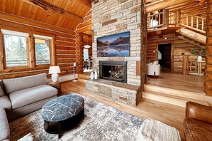 The sunken living room now has a large Smart TV above the cozy gas fireplace