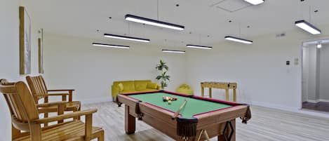 Game:Pool table with its accessories, including 2 wooden chairs for hanging out 