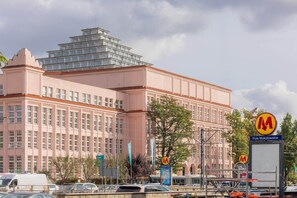An exterior view of a nearby building, emphasizing its vibrant urban surroundings and accessibility.
