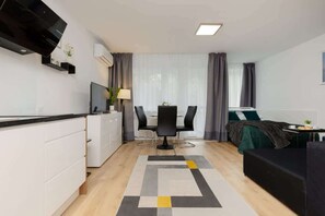A compact kitchen with white cabinetry, black appliances, and an integrated design for functionality.
