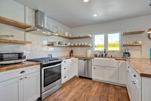 The airy kitchen is spacious & offers all the comforts of home