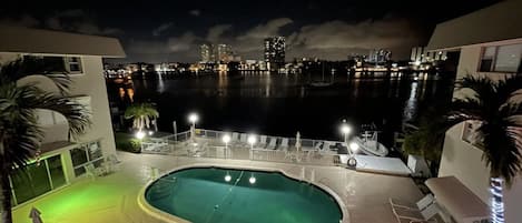 This is your view of the condo's heated pool with tables and seating. Grill too 